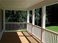 <b>View standing on the porch. White vinyl columns and railing, composite deck boards and a bead board finished ceiling</b>